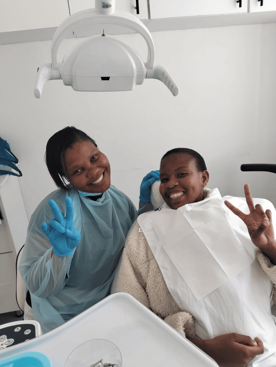 Dental healthcare professional with patient in treatment room