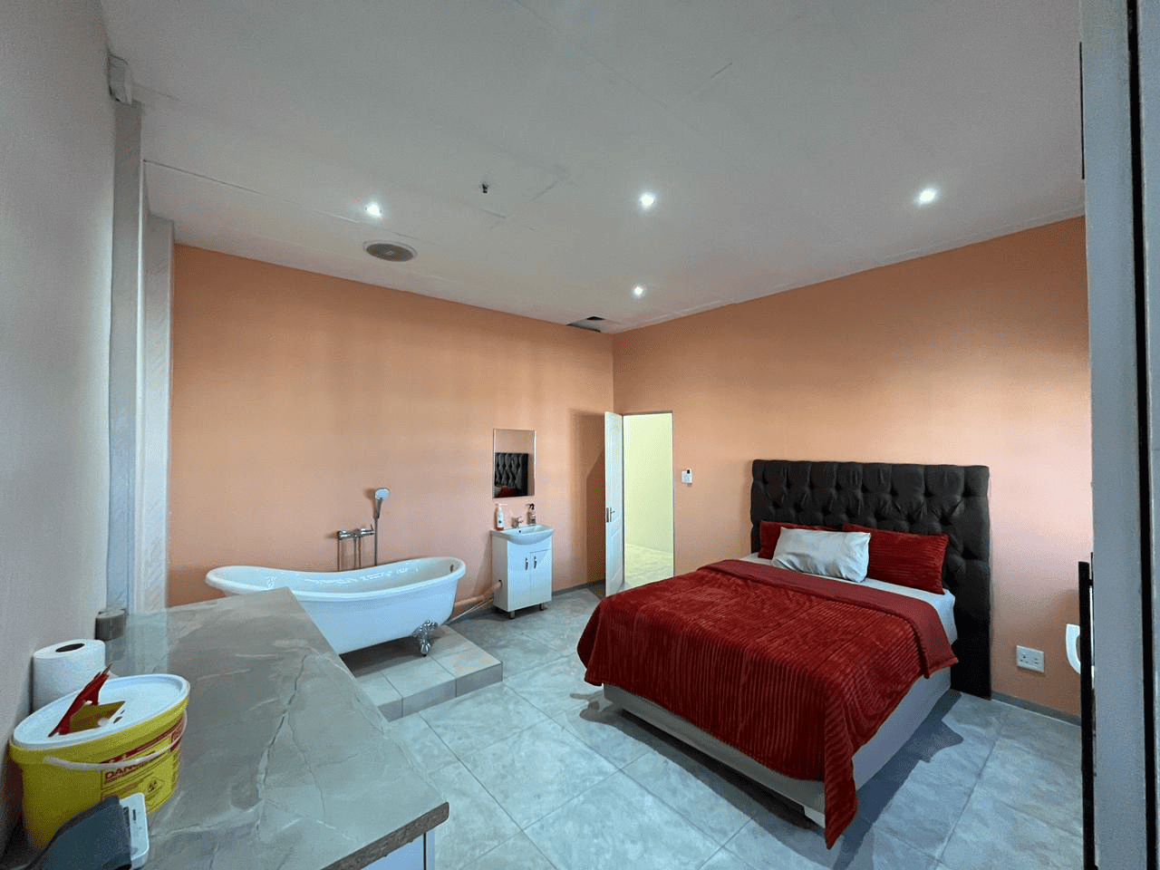 Private birthing suite with peach walls and a birthing bath at Phoenix Health Care in Edenvale